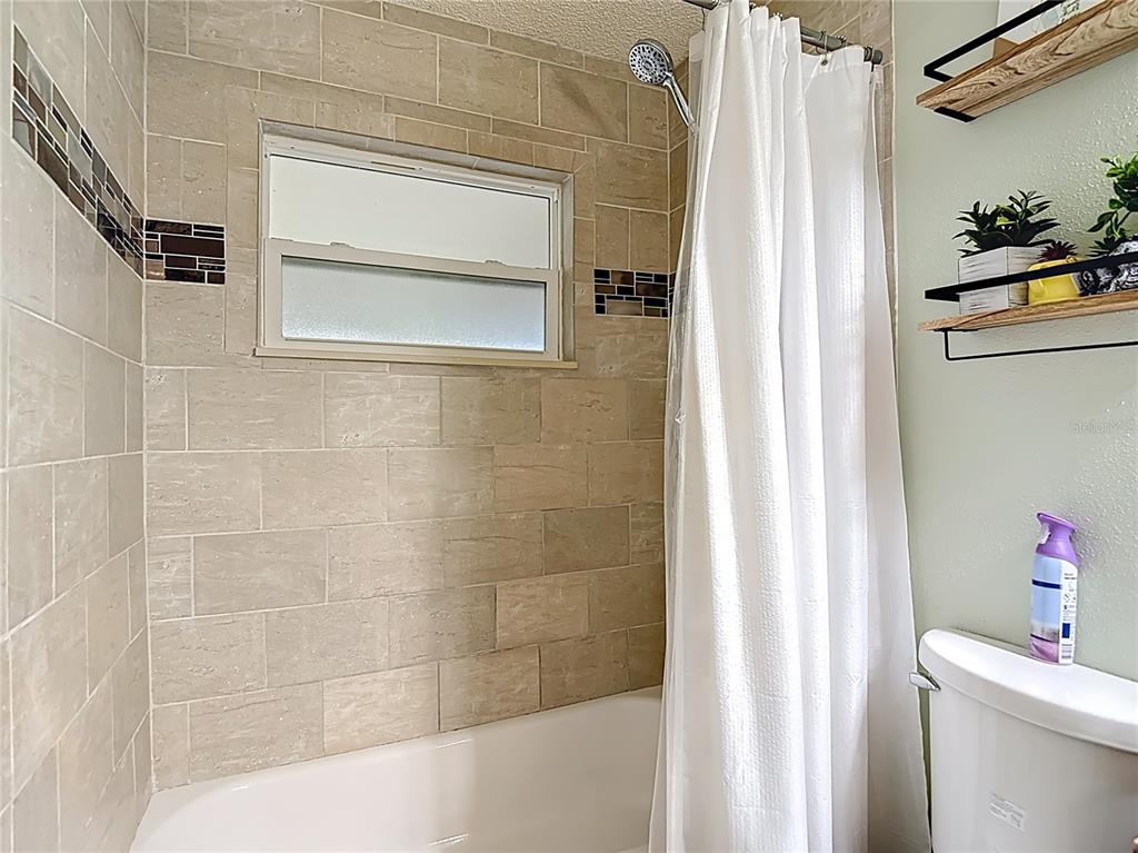 7318 Tranquil Drive Spring Hill, FL 34606 - Photo 26 of 38 a bathroom with a shower and a tub