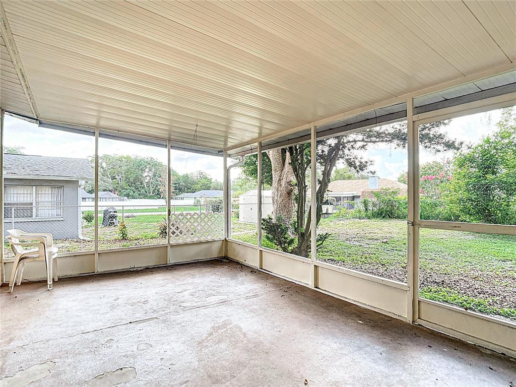 7318 Tranquil Drive Spring Hill, FL 34606 - Photo 27 of 31 a view of an empty room with wooden floor and door