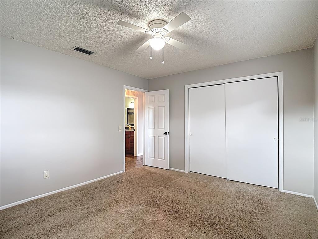 7318 Tranquil Drive Spring Hill, FL 34606 - Photo 28 of 38 a view of a livingroom with a ceiling fan and window