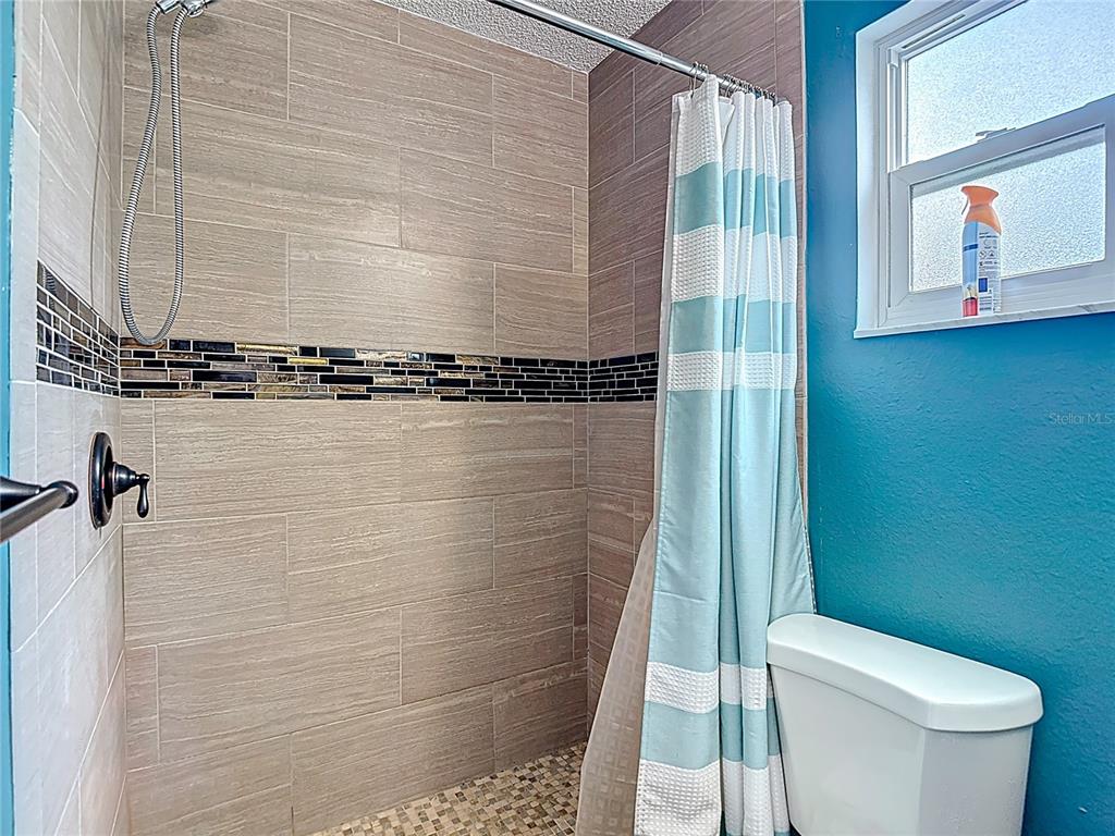 7318 Tranquil Drive Spring Hill, FL 34606 - Photo 29 of 38 a bathroom with a toilet and a shower