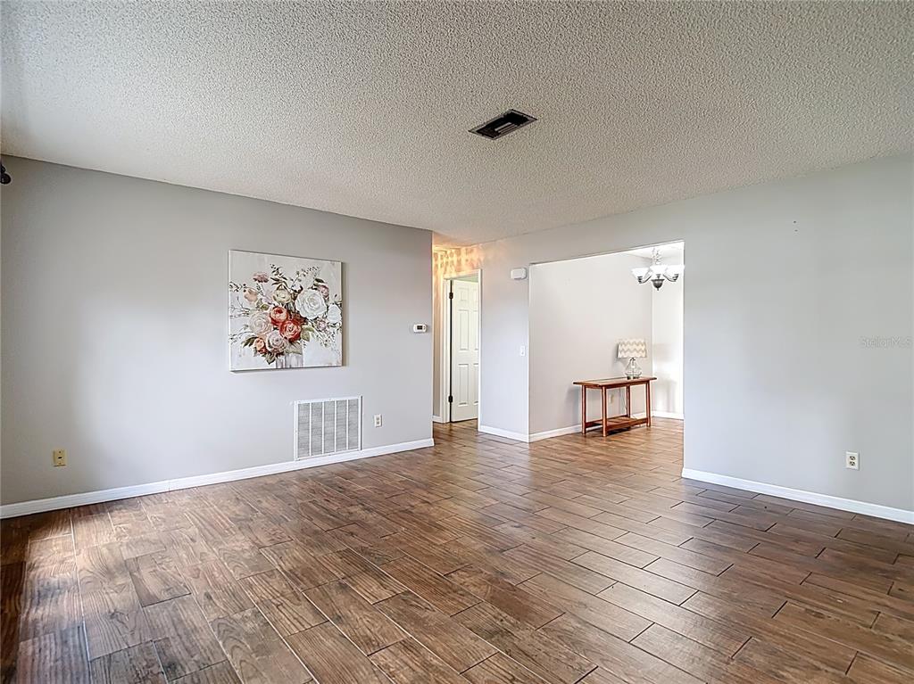 7318 Tranquil Drive Spring Hill, FL 34606 - Photo 3 of 38 a view of empty room with wooden floor