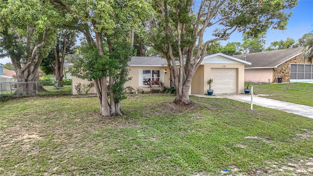 7318 Tranquil Drive Spring Hill, FL 34606 - Photo 3 of 38 front view of a house with a yard