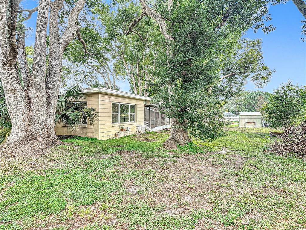 7318 Tranquil Drive Spring Hill, FL 34606 - Photo 34 of 38 a view of a house with backyard and garden