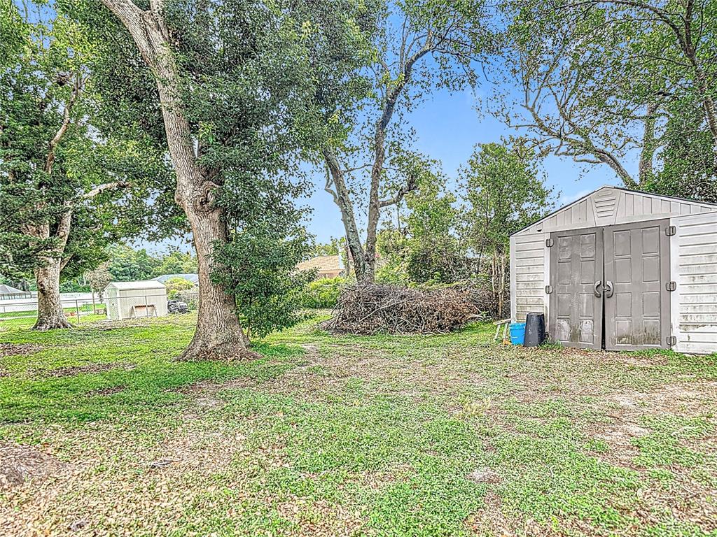 7318 Tranquil Drive Spring Hill, FL 34606 - Photo 38 of 38 a view of a big yard with a house and large trees