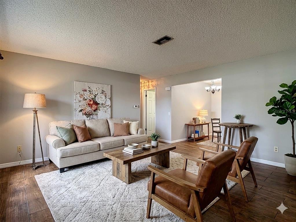 7318 Tranquil Drive Spring Hill, FL 34606 - Photo 5 of 38 a living room with furniture and a potted plant