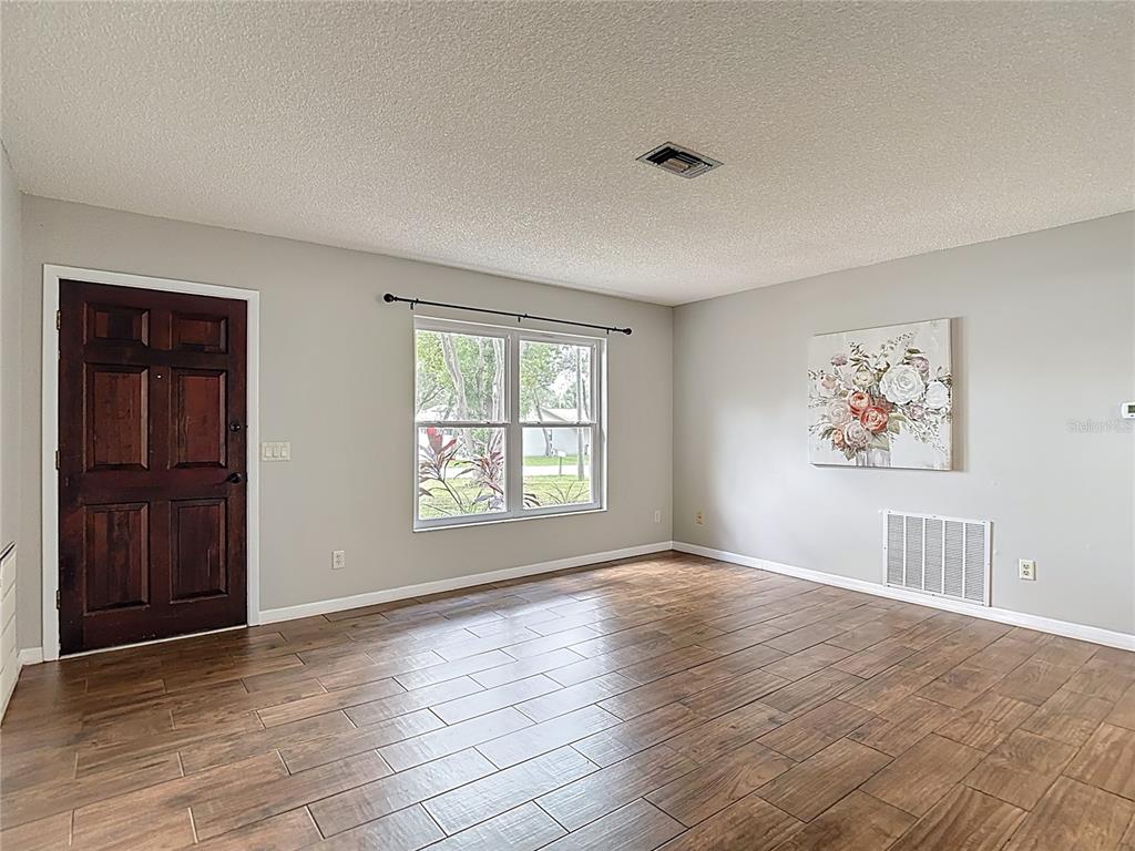 7318 Tranquil Drive Spring Hill, FL 34606 - Photo 6 of 38 an empty room with windows and closet