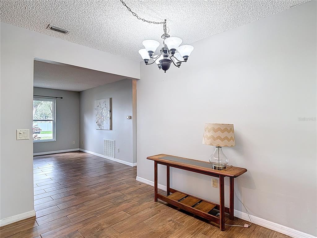 7318 Tranquil Drive Spring Hill, FL 34606 - Photo 9 of 38 a view of room with wooden floor and fan