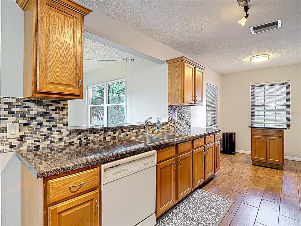 7318 Tranquil Drive Spring Hill, FL 34606 - Photo 10 of 31 a kitchen with granite countertop a sink and a stove