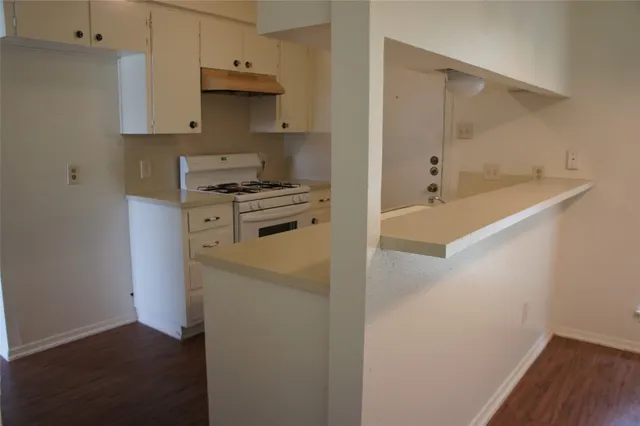 a kitchen with a stove and a refrigerator