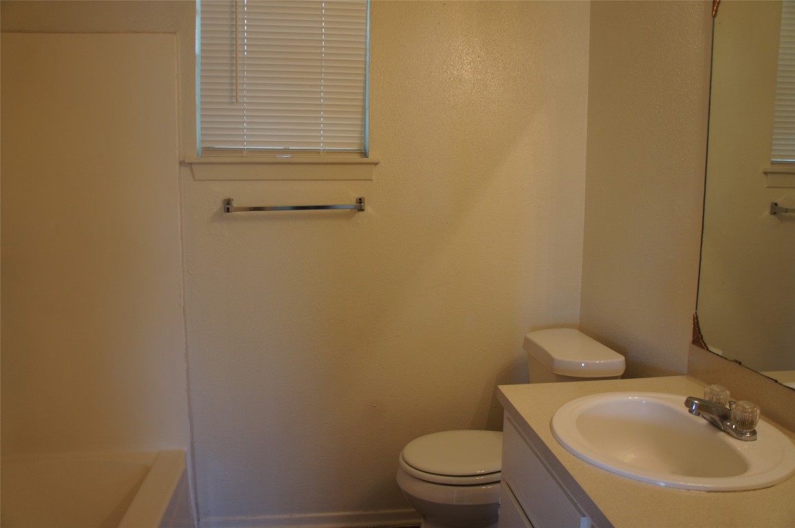 803 Power Road, Unit A Georgetown, TX 78628 - Photo 6 of 8 a bathroom with a sink and a toilet