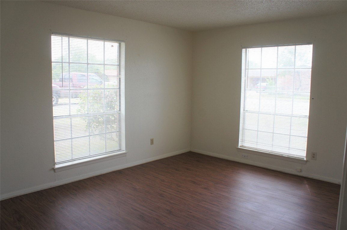 803 Power Road, Unit A Georgetown, TX 78628 - Photo 7 of 8 an empty room with wooden floor