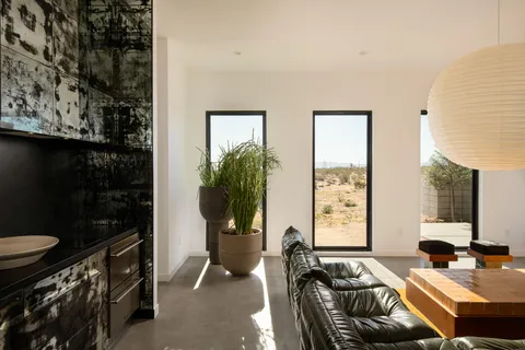 a bedroom with a bed and glass door
