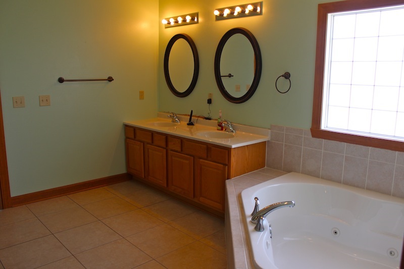 645 Merrion Road Roscoe, IL 61073 - Photo 16 of 24 a bathroom with a sink and a mirror