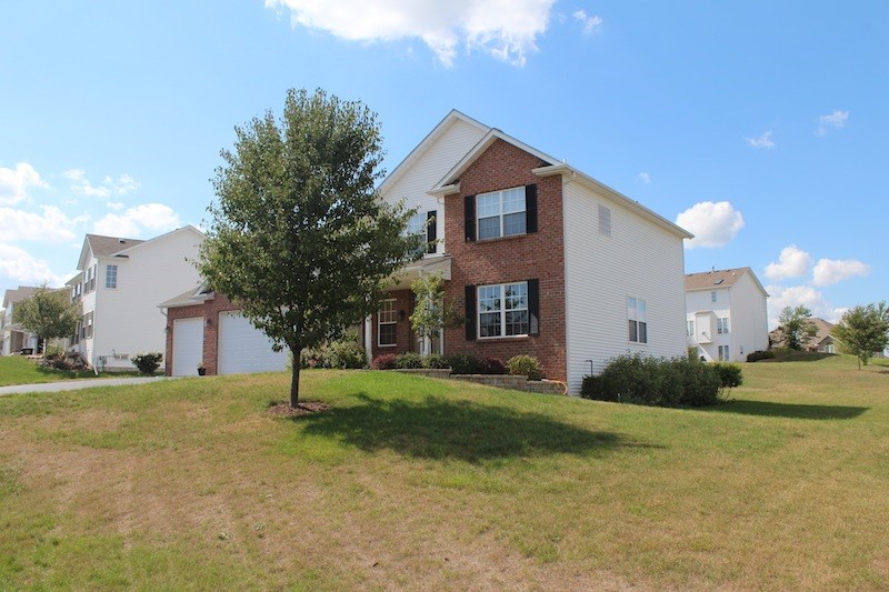 645 Merrion Road Roscoe, IL 61073 - Photo 2 of 24 a front view of a house with a yard