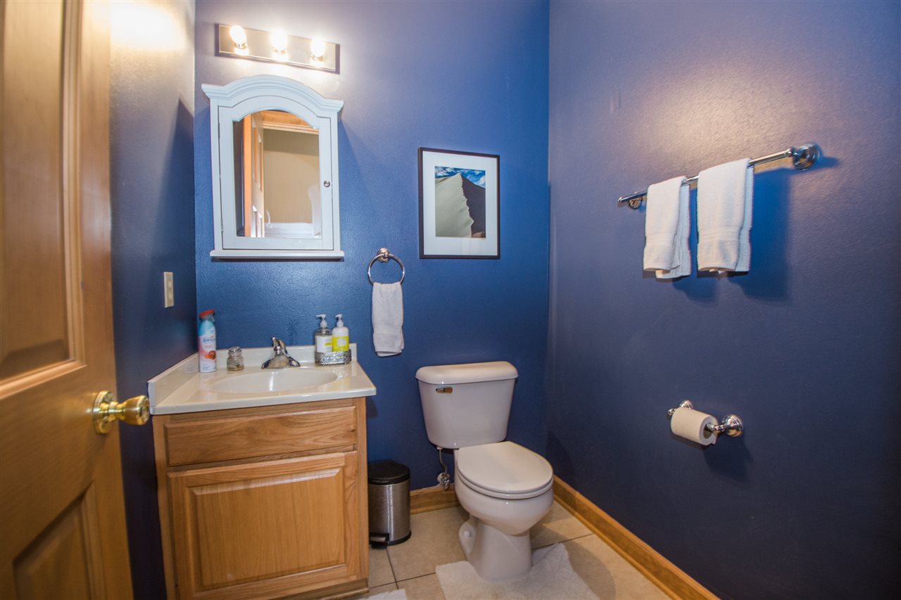 645 Merrion Road Roscoe, IL 61073 - Photo 21 of 24 a bathroom with a toilet sink vanity and mirror