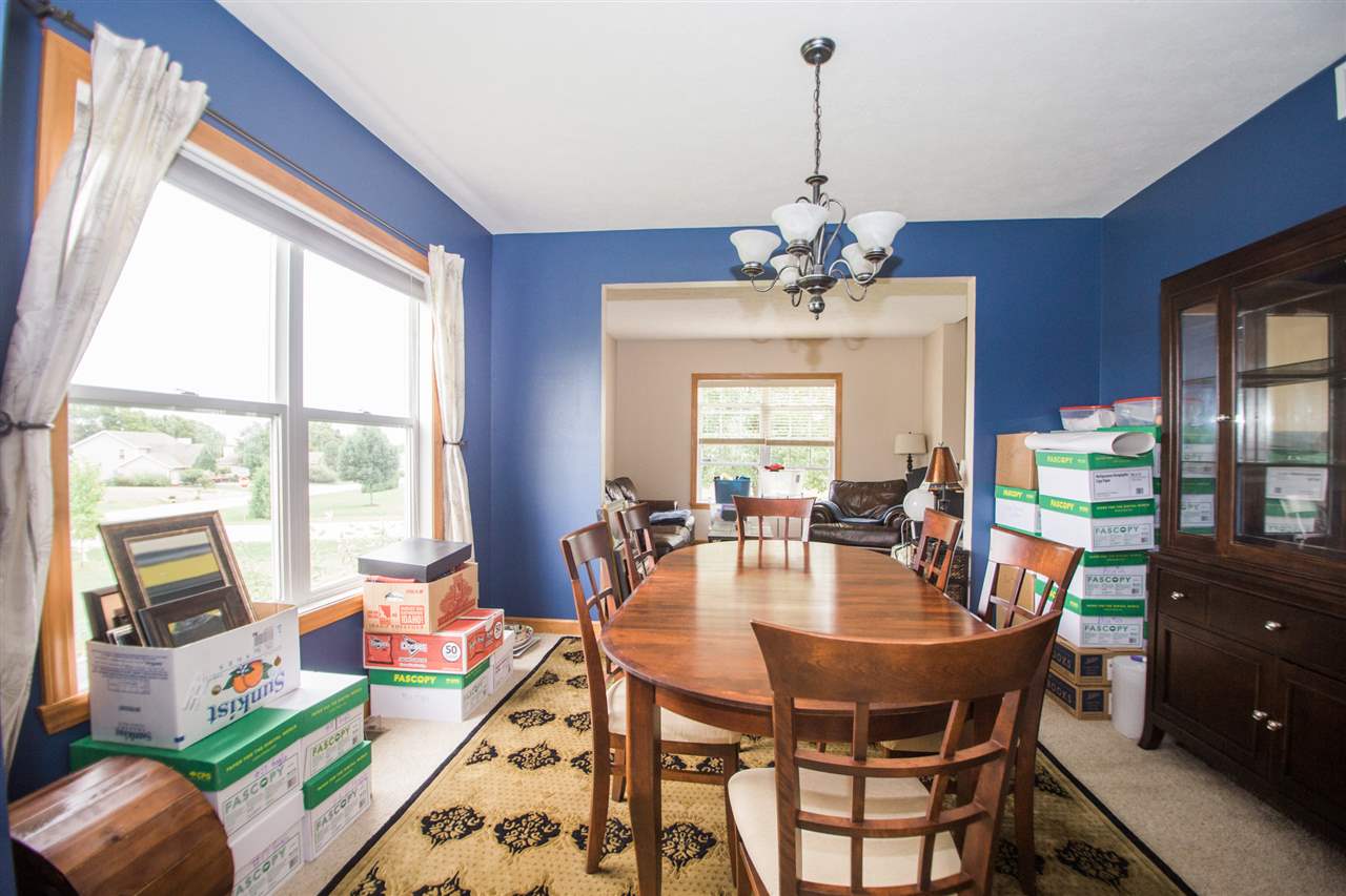 645 Merrion Road Roscoe, IL 61073 - Photo 8 of 24 a dining room with furniture a chandelier and a rug
