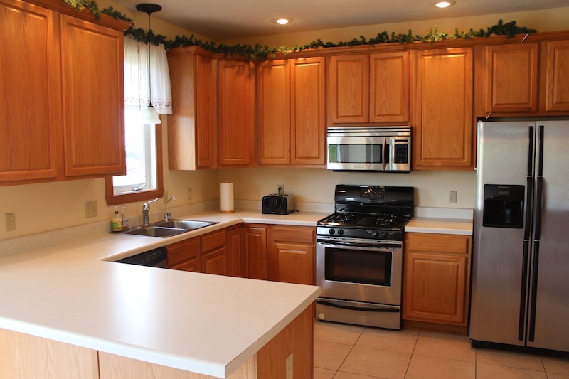 645 Merrion Road Roscoe, IL 61073 - Photo 9 of 24 a kitchen with granite countertop a stove and a refrigerator