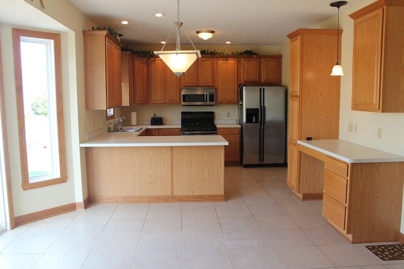 645 Merrion Road Roscoe, IL 61073 - Photo 10 of 24 a kitchen with a sink stove and refrigerator