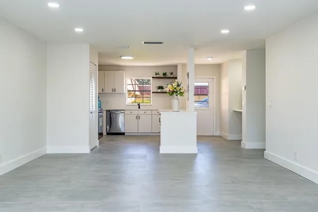 a view of kitchen with kitchen island and stainless steel appliances