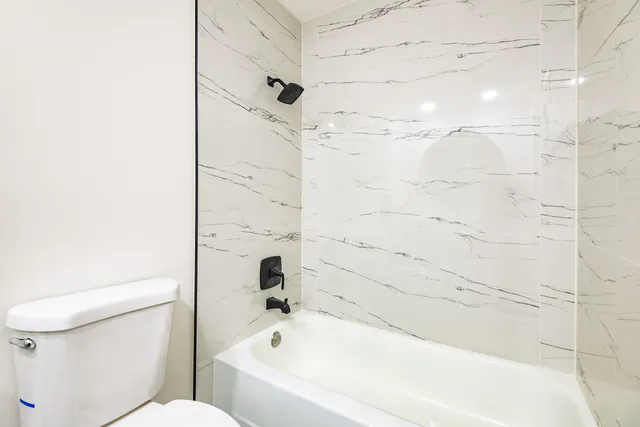 a bathroom with a bathtub and a toilet