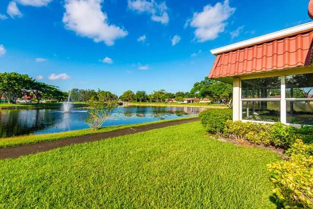 a view of a house with a yard and a lake view