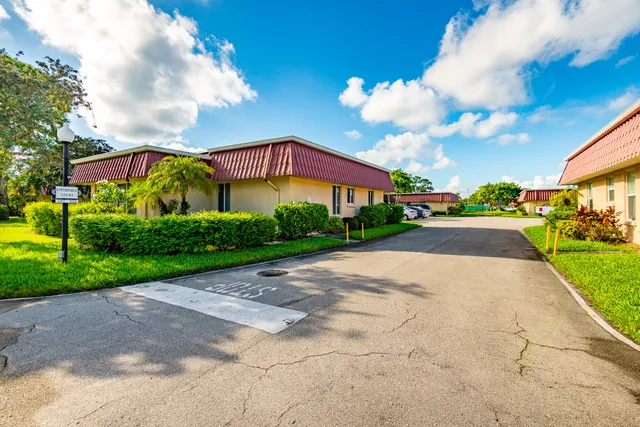 a front view of a house with a yard and a street