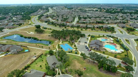an aerial view of residential houses with outdoor space
