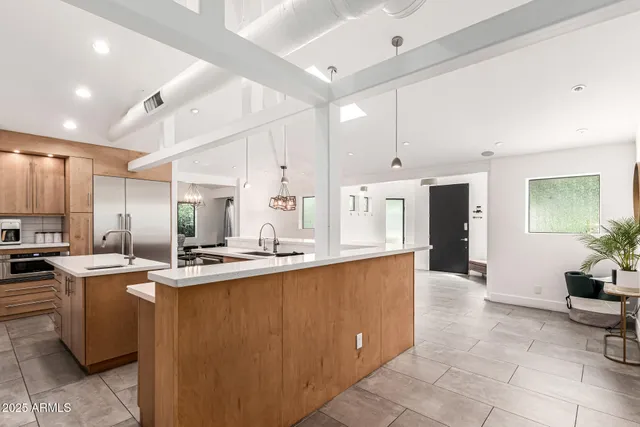 a living room with furniture a flat screen tv and a large window