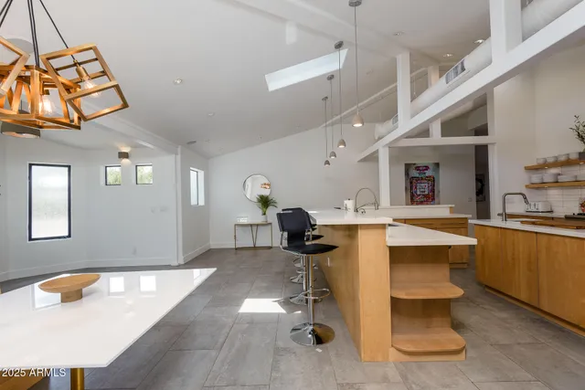 a view of a dining room with furniture a chandelier and wooden floor