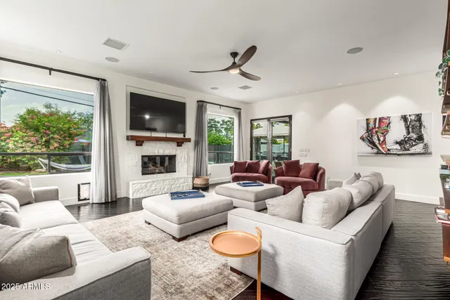 a living room with furniture fireplace and flat screen tv