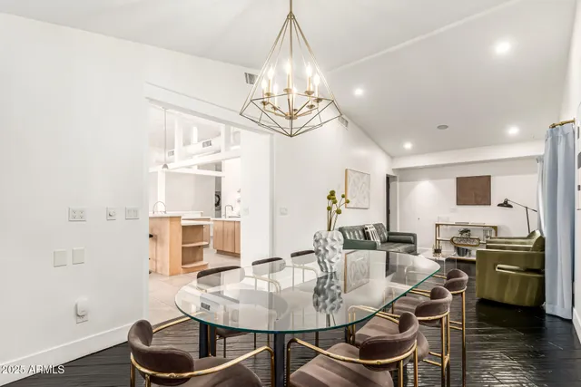 a en suite bathroom with a granite countertop double vanity sink a mirror and a bathtub