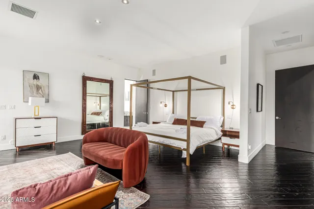 a bedroom with a large bed and a window