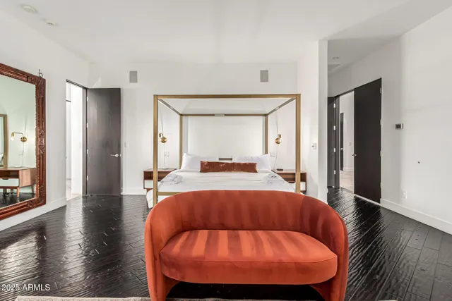 a bedroom with a bed and a television