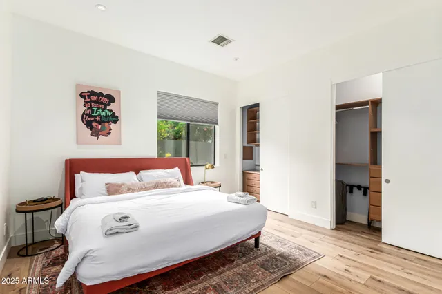 a view of a patio with couches table and chairs with wooden fence