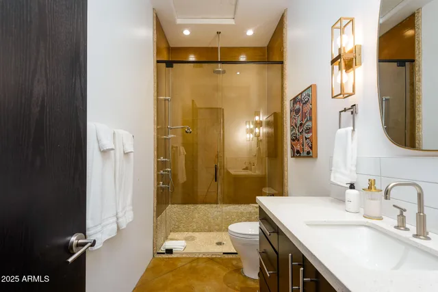 a view of a patio with a table and chairs under an umbrella