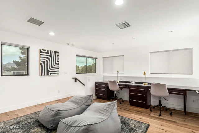 a view of a backyard with couches plants and large trees