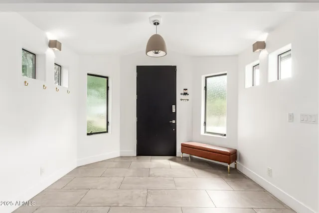 a large kitchen with a table and chairs