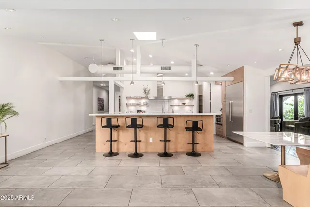 a dining room with wooden floor and a chandelier