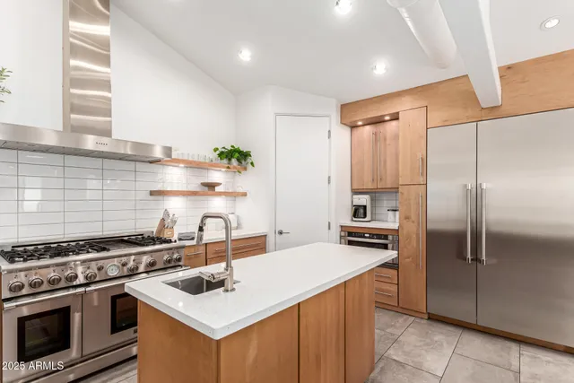 a stove top oven sitting inside of a kitchen