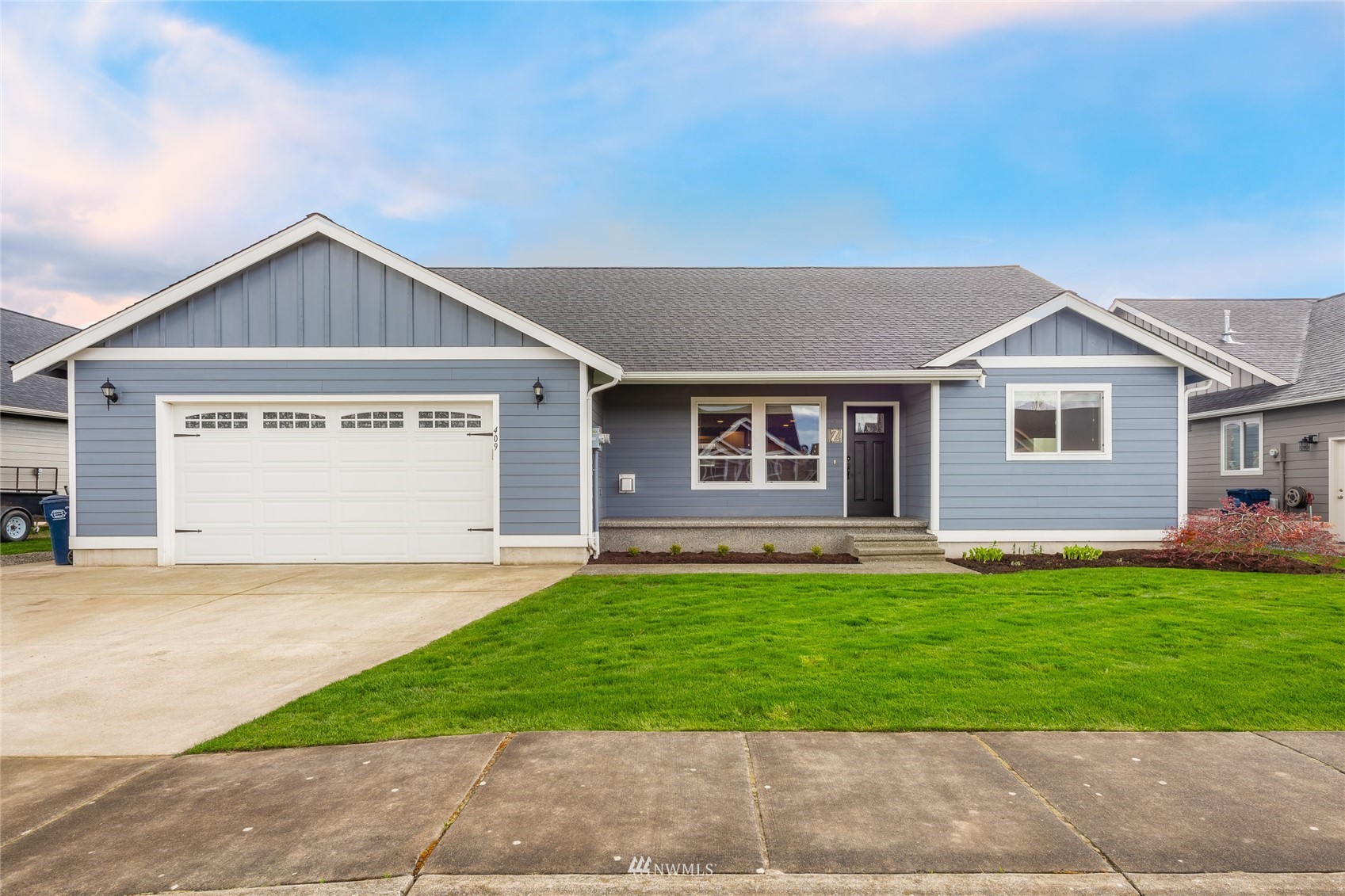 409 Amareen Court Nooksack, WA 98276 - Photo 1 of 35 a front view of a house with a yard and garage