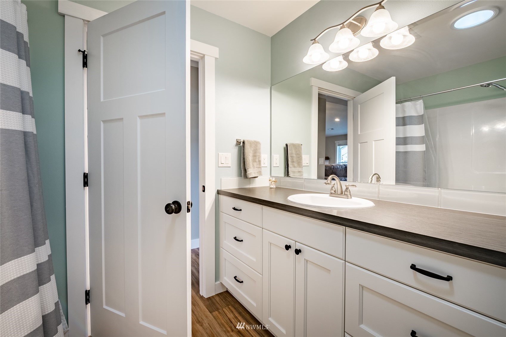 409 Amareen Court Nooksack, WA 98276 - Photo 16 of 35 a bathroom with a sink a vanity and a mirror