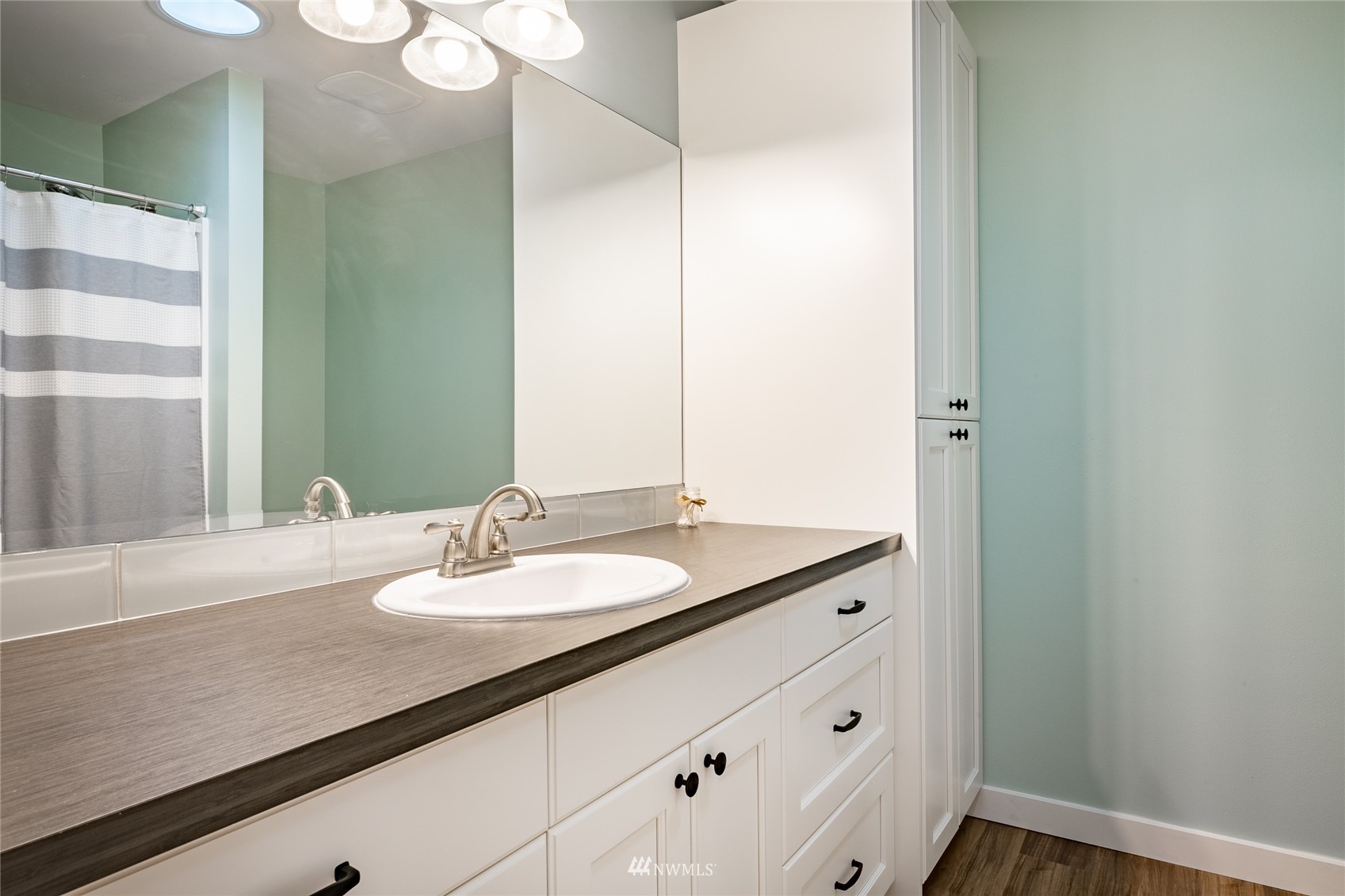 409 Amareen Court Nooksack, WA 98276 - Photo 17 of 35 a bathroom with a granite countertop sink and a mirror