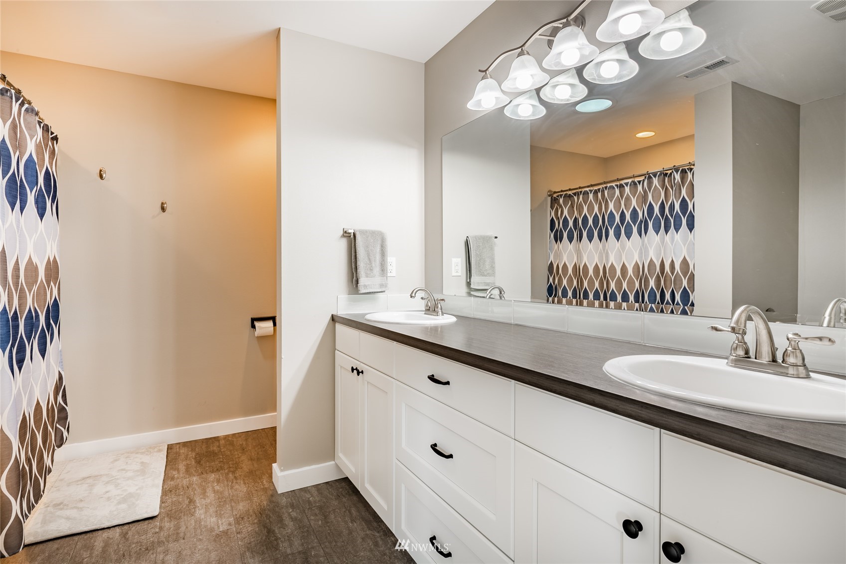 409 Amareen Court Nooksack, WA 98276 - Photo 19 of 35 a bathroom with a double vanity sink and a mirror