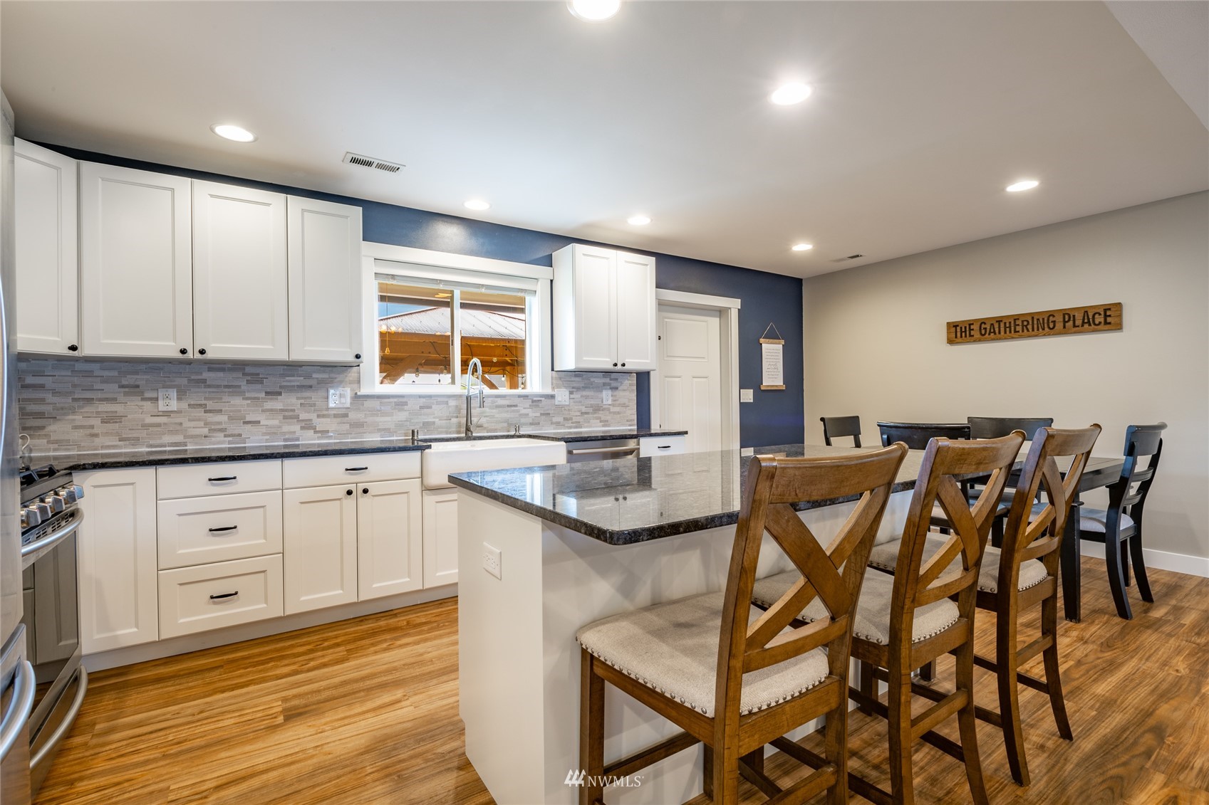 409 Amareen Court Nooksack, WA 98276 - Photo 10 of 35 a kitchen with stainless steel appliances granite countertop a table chairs sink and cabinets
