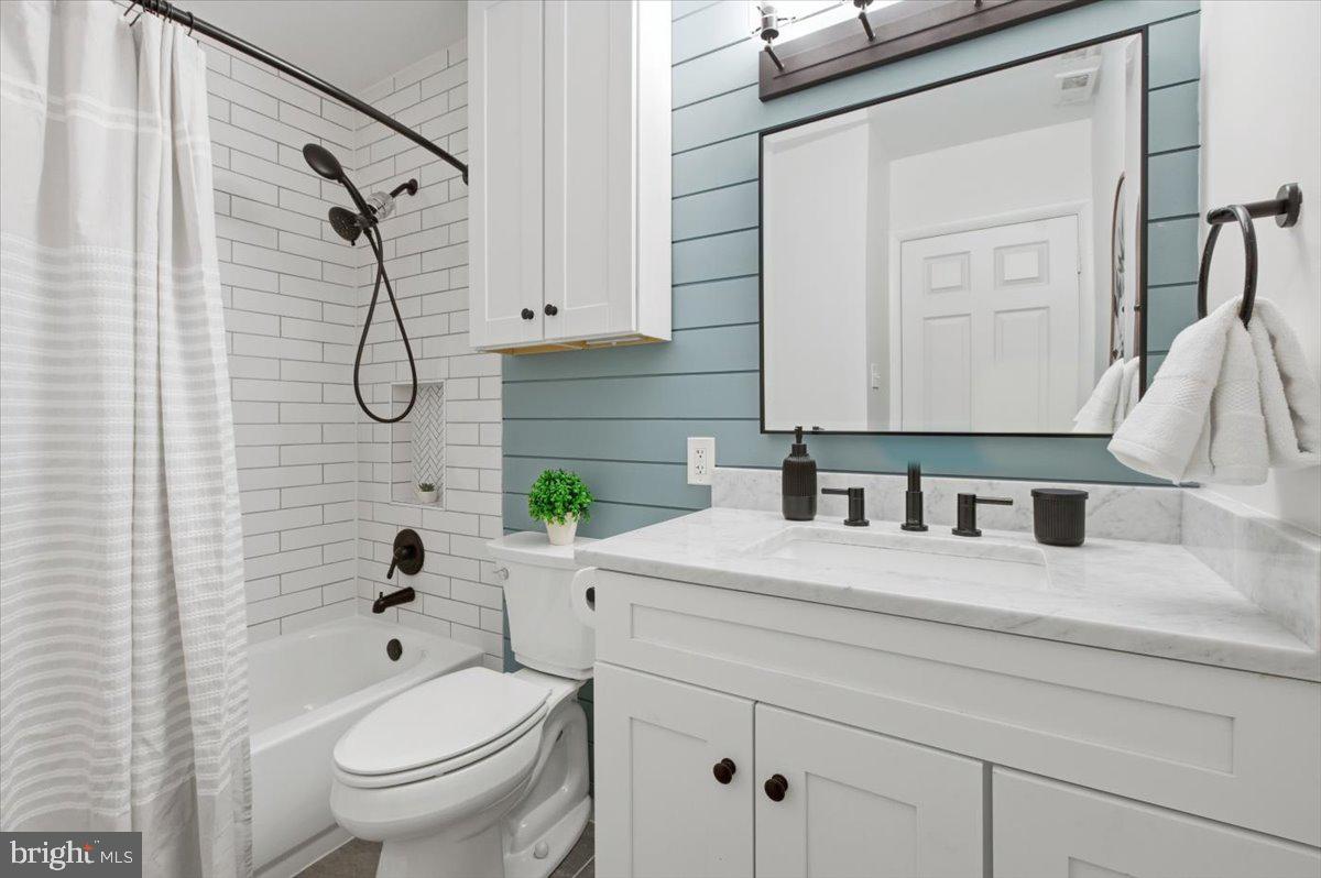 6906 Sprouse Court Springfield, VA 22153 - Photo 13 of 37 a bathroom with a granite countertop sink a toilet and shower