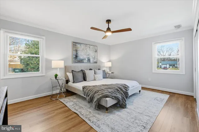 a bedroom with a bed a table and painting on the wall