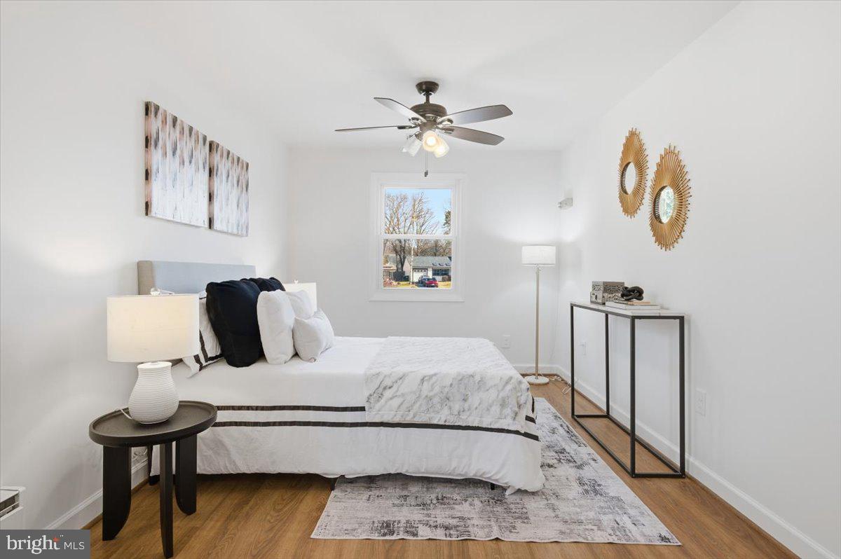 6906 Sprouse Court Springfield, VA 22153 - Photo 25 of 37 a bedroom with a bed and wooden floor