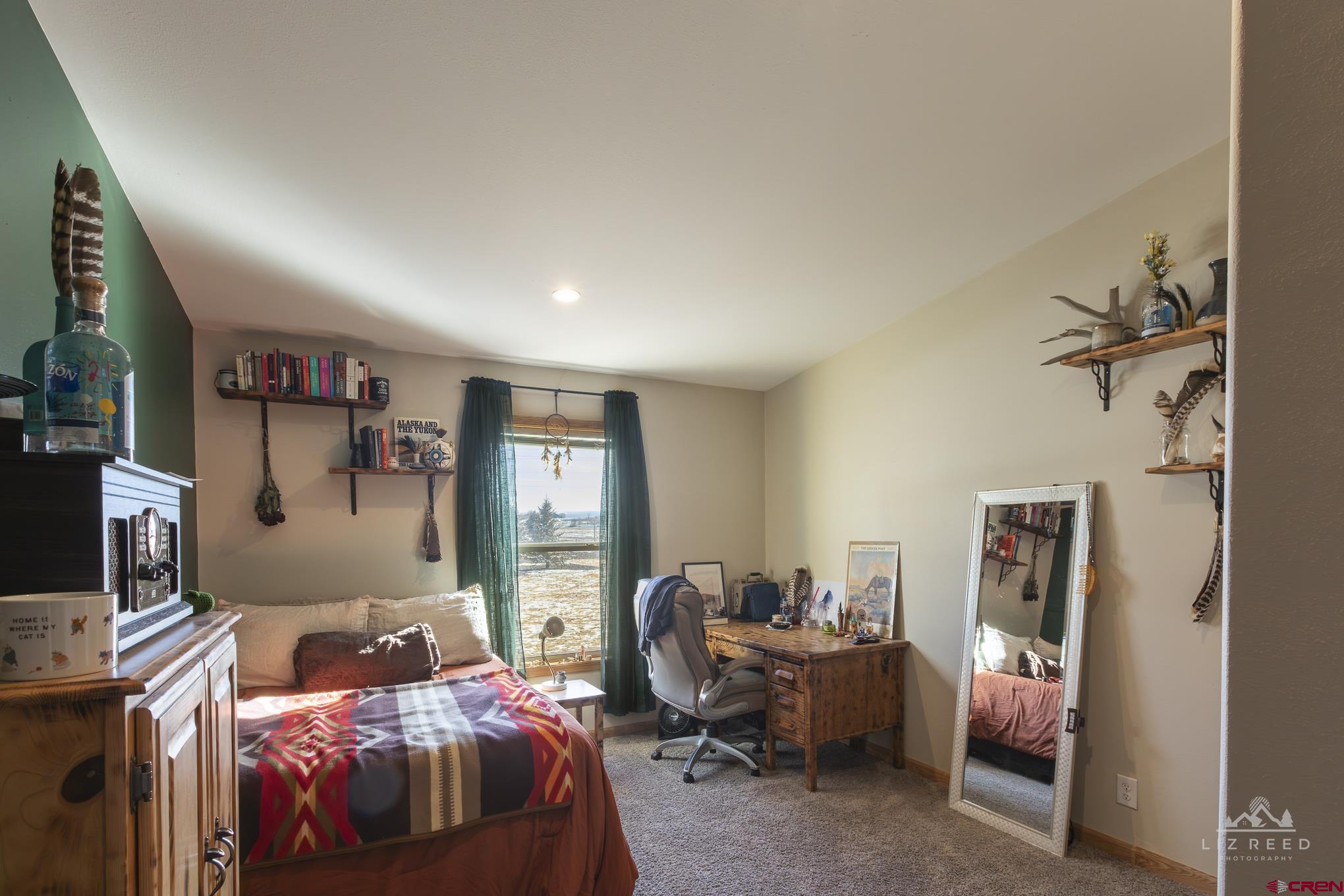 55339 Begonia Road Delta, CO 81416 - Photo 11 of 34 a bedroom with a bed and a couch
