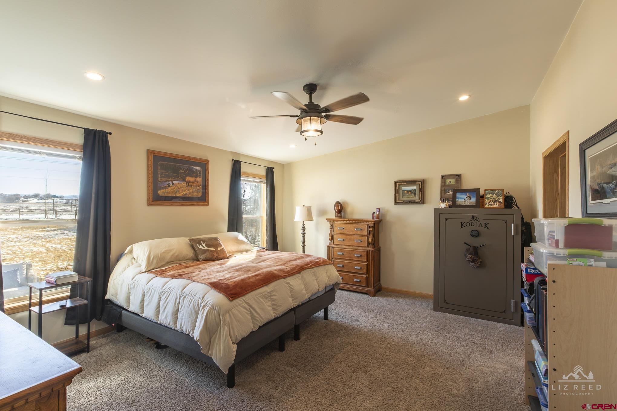 55339 Begonia Road Delta, CO 81416 - Photo 14 of 34 a bedroom with a bed dresser and a large window