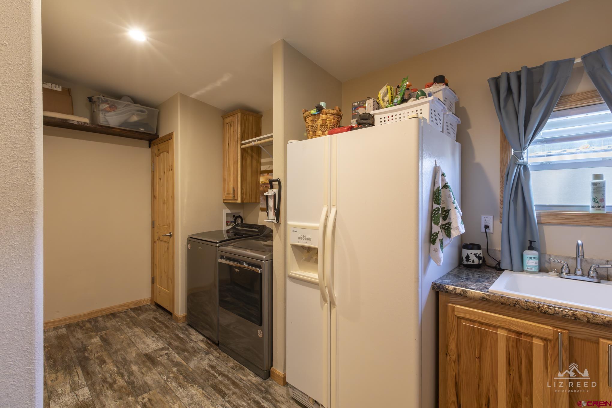 55339 Begonia Road Delta, CO 81416 - Photo 16 of 34 a white refrigerator freezer and a stove sitting inside of a kitchen